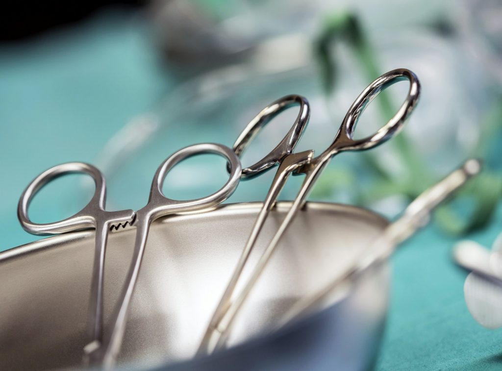 Some scissors for surgery on a tray, conceptual image - Guía completa del injerto capilar: Qué esperar antes, durante y después del tratamiento - Uve Medical, clinica de estetica facial y capilar