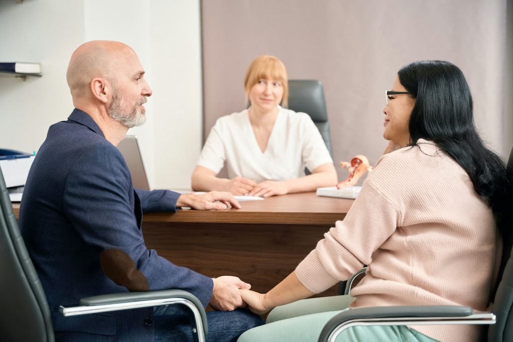 Husband and wife visiting reproductologist at private medical clinic